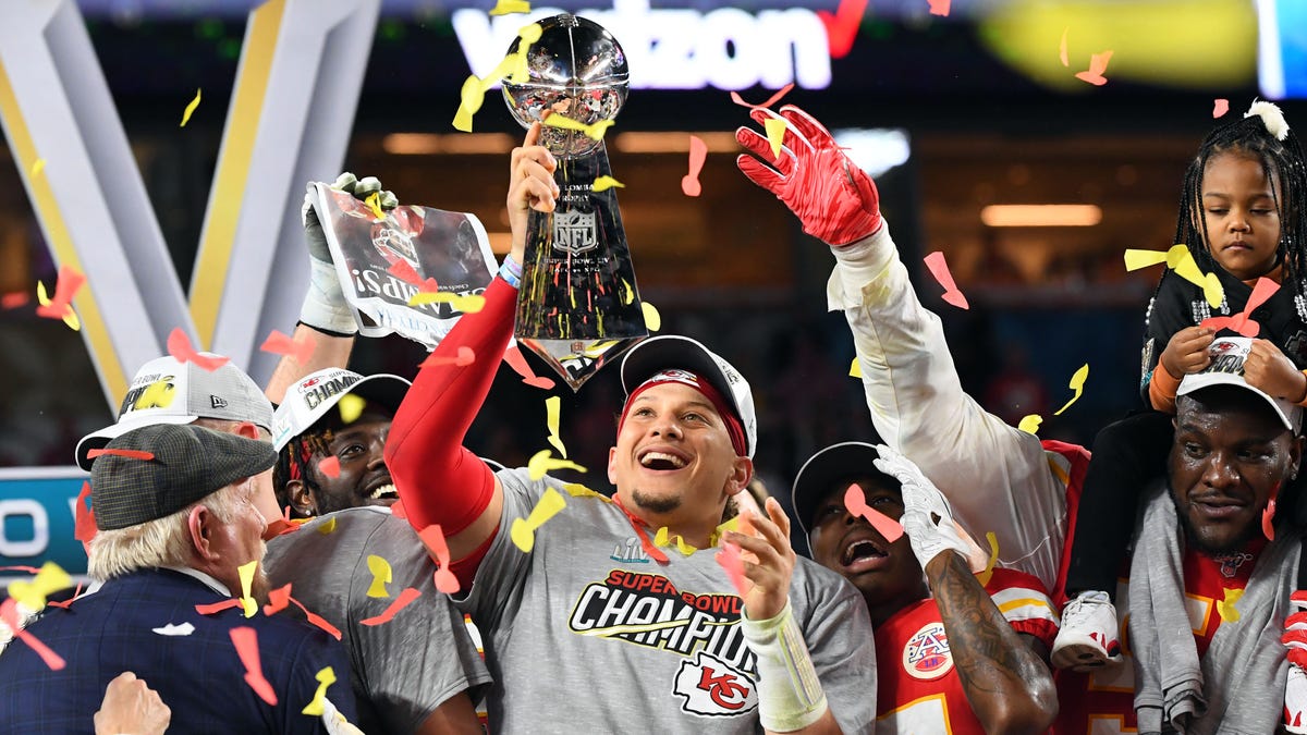 Chiefs quarterback Patrick Mahomes hoists the Vince Lombardi Trophy after defeating the 49ers in Super Bowl LIV at Hard Rock Stadium.