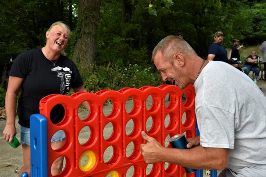 Kenda McClain laughs after Dan VanDyke defeated her in a game of Giant Connect 4 as part of adult recess presented by Penetrator Events and hosted at Territorial Brewing Company in Springfield on Thursday, Sept. 3, 2020.