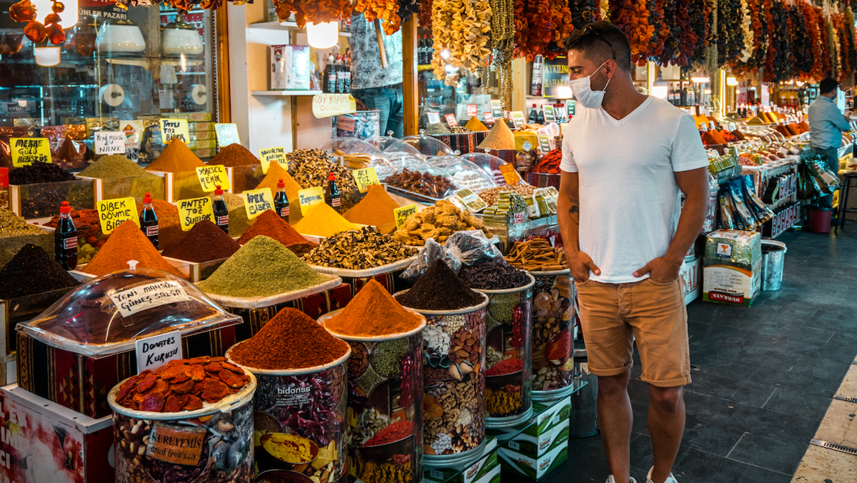 Alvaro Rojas walking in a market wearing a mask in Turkey.