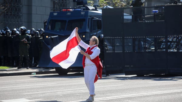 Woman holding the opposition flag