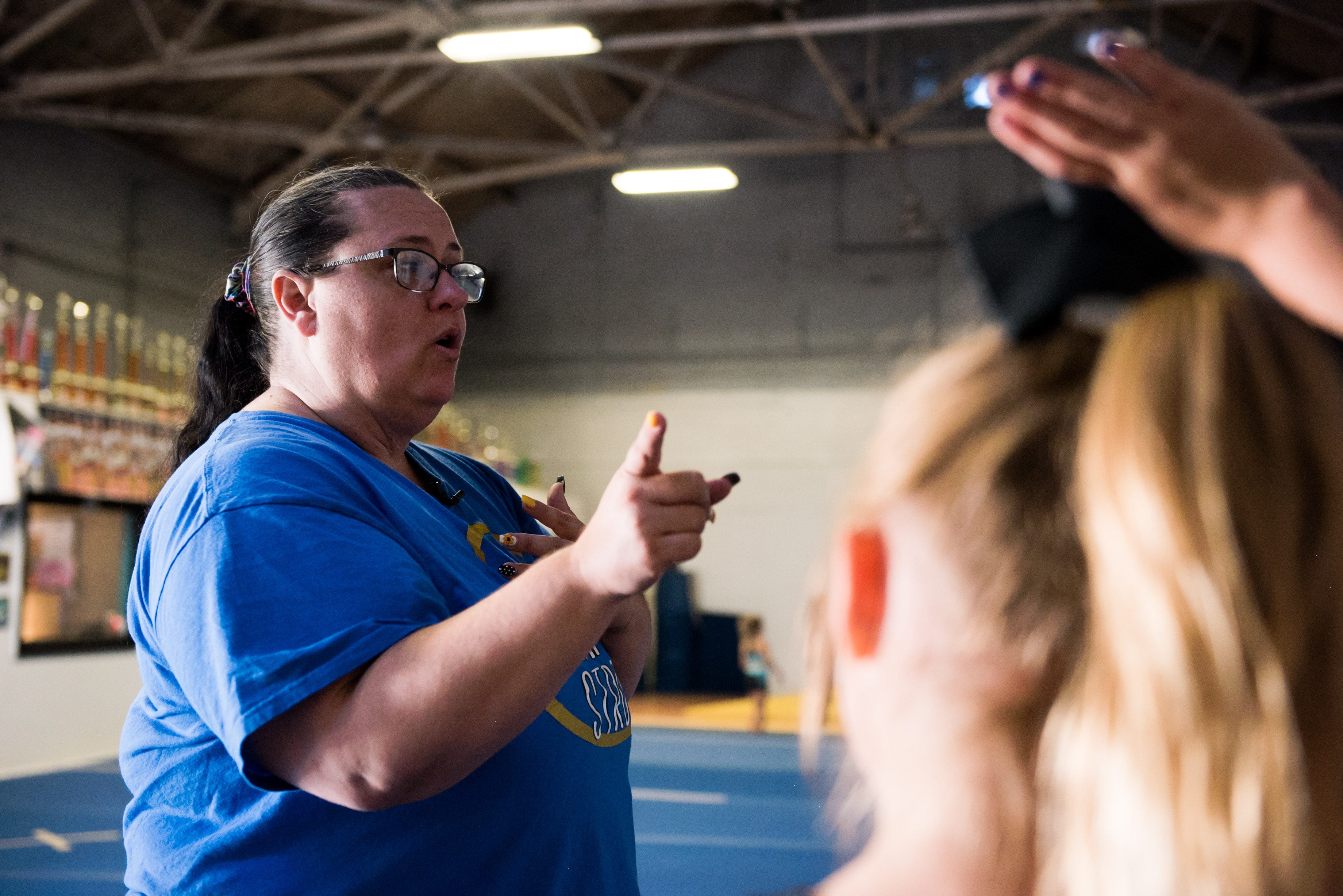 Mishelle Robinson talks to cheerleaders at Empire All Stars in Ravenna, Ohio.