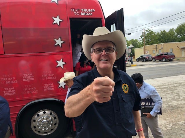 Lt. Gov. Dan Patrick prepares to exchange a fist bump with a reporter at a campaign stop on behalf of former President Donald Trump in Granger in September 2020.