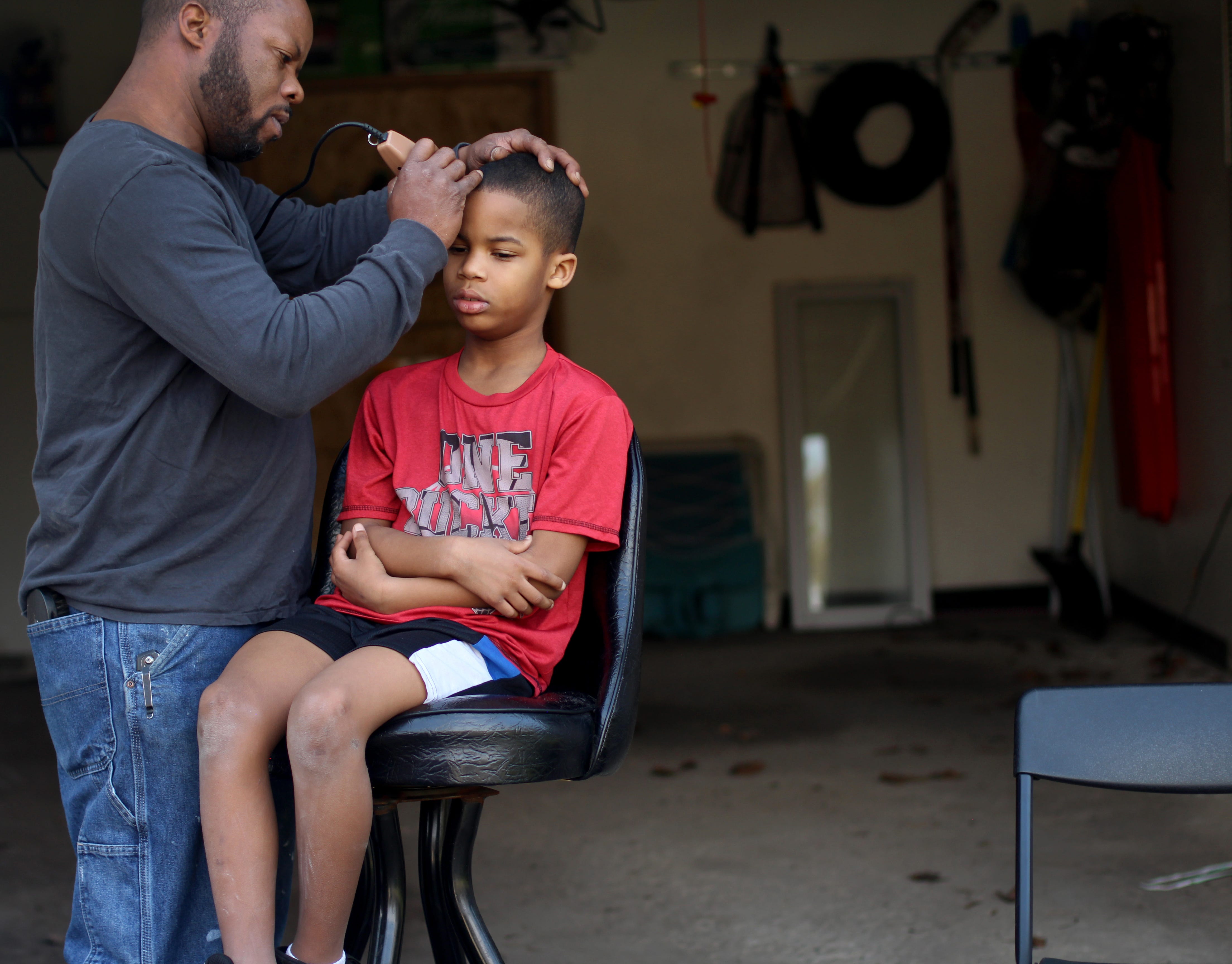 This photo was taken the day I got my first camera - a Canon Rebel T5. The governor closed down barbershops and my eight-year-old brother Cassius Hill's hair was growing very fast so my dad, Contonmio Hill, 49, gave him a quick lineup in our backyard in Redford on April 28, 2020.