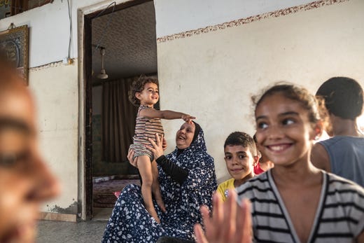 Suad Al-Dairi plays with her grandson in their house during a coronavirus lockdown in the Al-Karamah neighborhood on September 02, 2020 in Gaza City, Gaza.