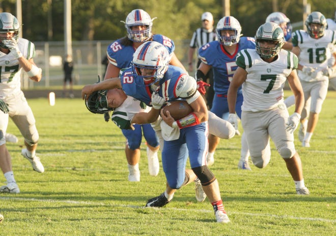 Noah Clark tries to shed a tackle attempt by Madison linebacker Phil Stupka.