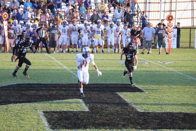 Bethel's Drae Wood (11) runs after catching a ball down the middle against Meeker Friday night. Pursuing on the play for Meeker are Bobby Brooks (21) and Caleb Chapman (5).