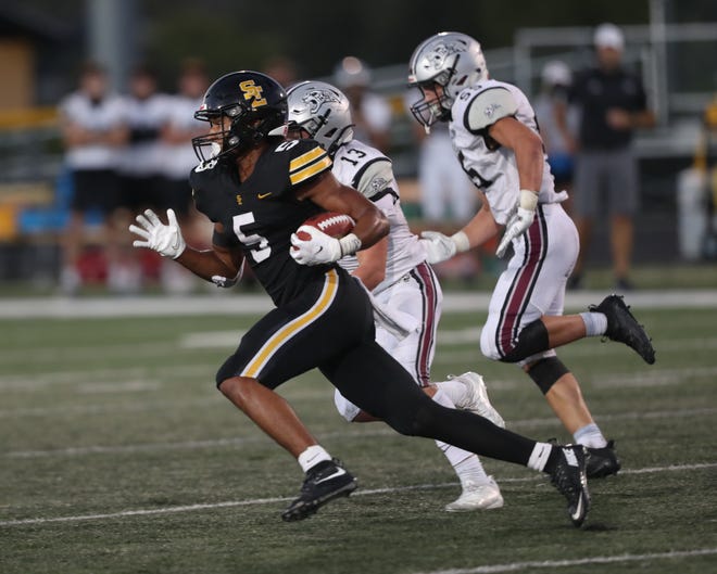 SE Polk Rams Xavier Nwankpa (5) runs for a touchdown against the Centennial Jaguars at SE Polk High School on Sept. 4, 2020.