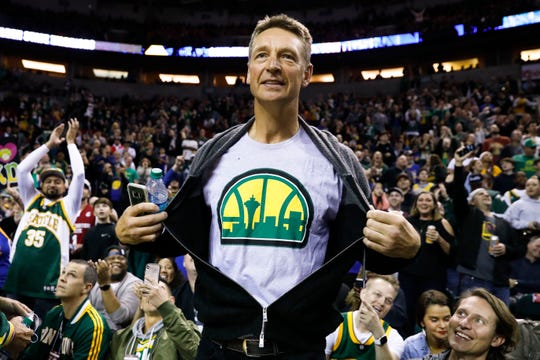 Former Seattle Supersonics forward Detlef Schremph (11) shows off a Sonics t-shirt during a pregame between the Sacramento Kings and Golden State Warriors at KeyArena in 2018.