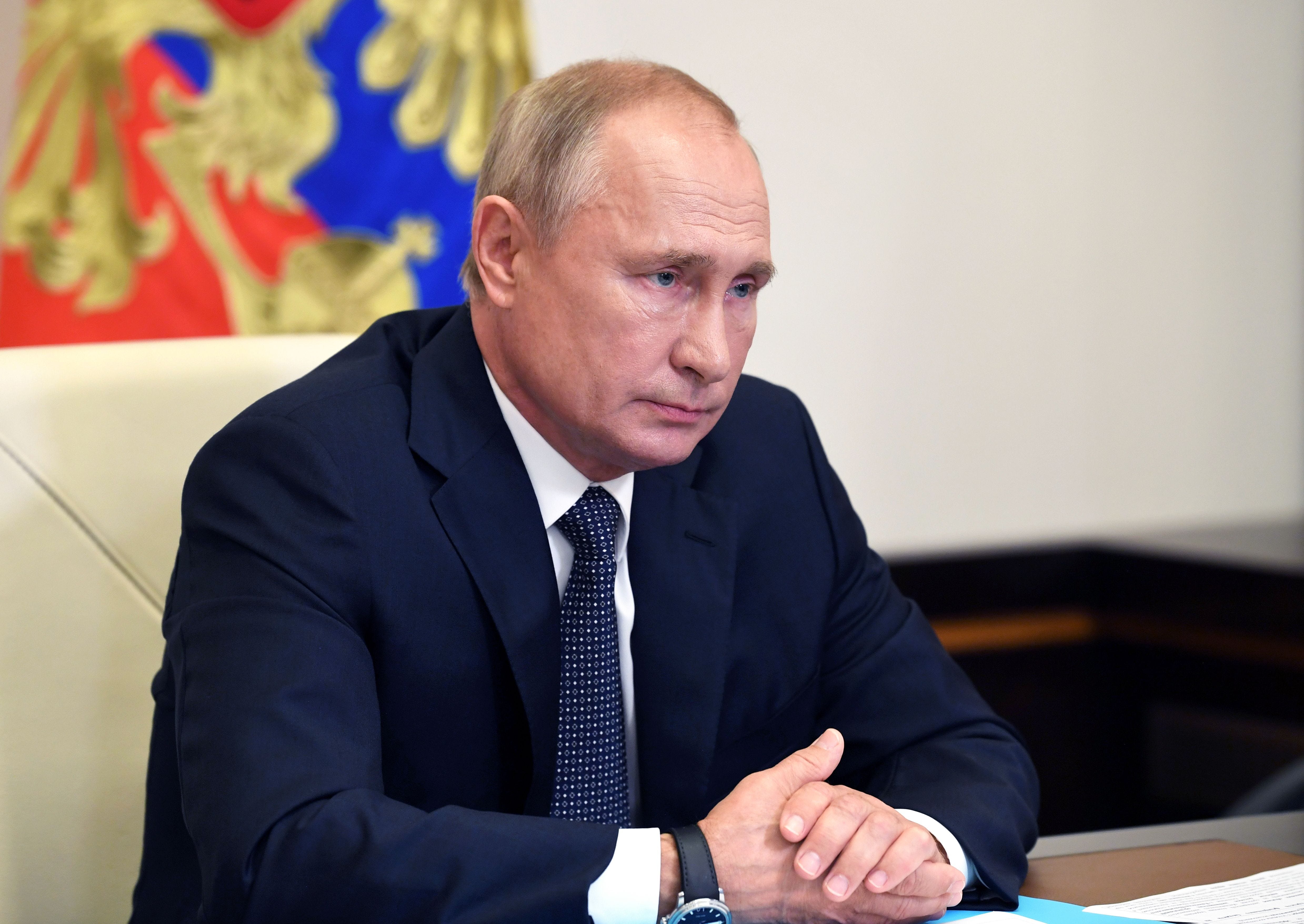 Russian President Vladimir Putin chairs a meeting with members of the government via a teleconference call.