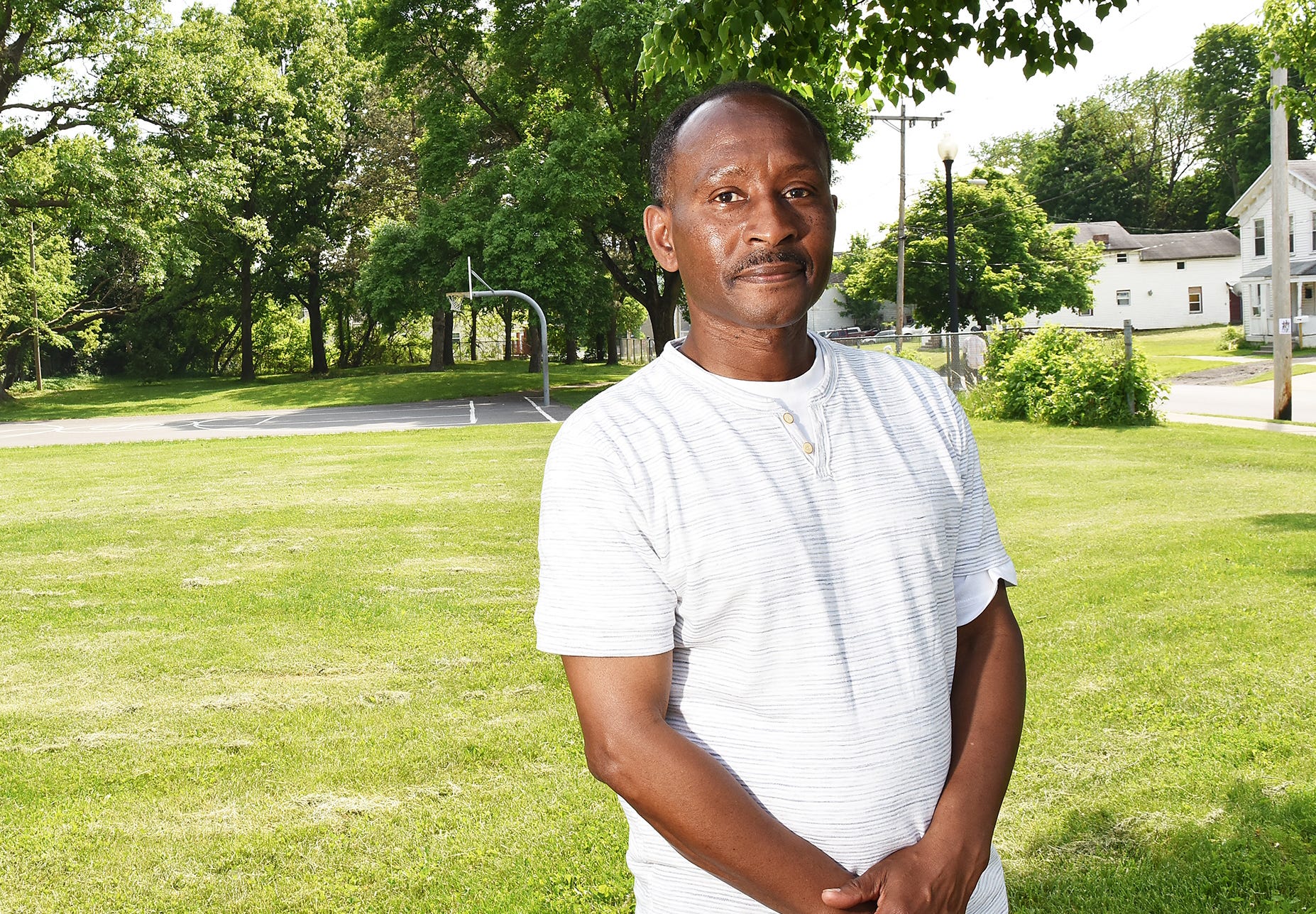 Patrick Johnson stands in the park at the corner of South and Steuben in Utica, NY, on Wednesday, May 30, 2018.