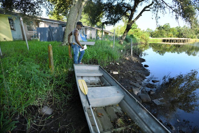 Ken Knight Drive resident Alton Gordon checks on his rowboat along the banks of the Ribault River. The river usually flows peacefully by the northwest Jacksonville neighborhood, but it surged over the banks in 2017 during Hurricane Irma when Gordon used the boat to bring stranded residents to higher ground. A $5 million flood-hazard program will offer buy-outs to dozens of property owners.