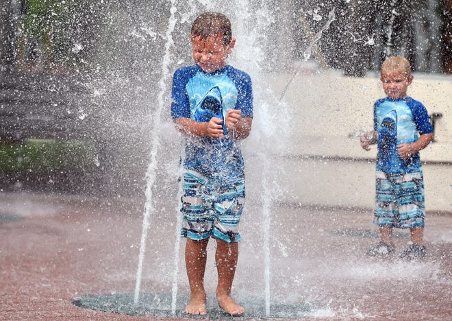 After a day of home schooling with their mother, Alexis Grieco, Xavier, 5, and Oliver, 3, cool off at The Children’s Fountain in Venice on Tuesday. The fountain, in Centennial Park, is open daily from 9:30 a.m.-9:30 p.m. Visitors are asked to observe social distancing guidelines and avoid congregating in large groups. The city’s mask ordinance remains in effect in both indoor and outdoor areas when social distancing cannot be maintained, but children under the age of 6 are exempt.
