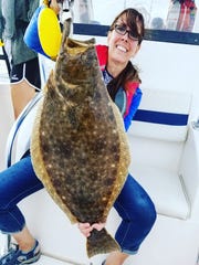 Tia DiGavero with a 10.5-pound doormat fluke she caught drifting off the point of Sandy Hook.