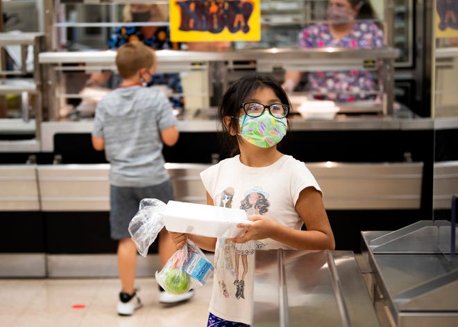 Students pick up lunch at Adrian Burnett Elementary in Knoxville, Tenn., on Tuesday, Sept. 8, 2020. A federal extension allows schools nationwide to provide free lunches for anyone under 18 through the end of the year.