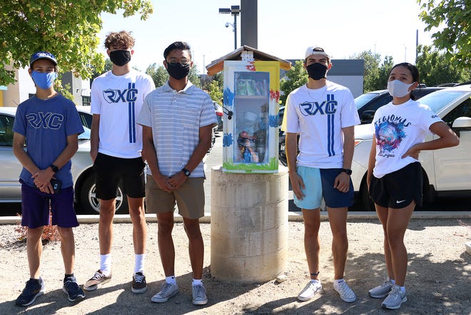 Members of the Reed High School cross country team unveil their Karma Box at the Boys and Girls Club of Truckee Meadows in Sparks on Sept. 8, 2020. 