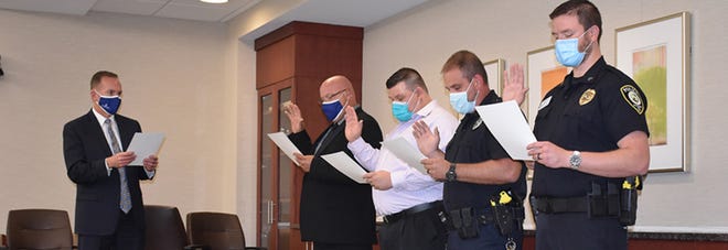 Craig Kinyon, the president and chief executive officer of Reid Health, leads the swearing in of Sgt. Brian Jackson, Officer Mike Hurst, Officer Ryan Gerber and Sgt. Brian Bolin to the Reid Health Police Department.