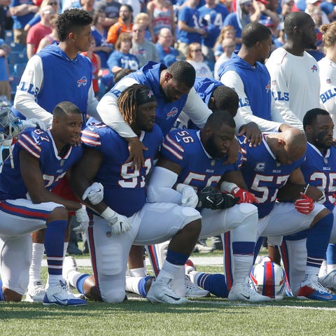 Members of the Buffalo Bills kneel in protest duri