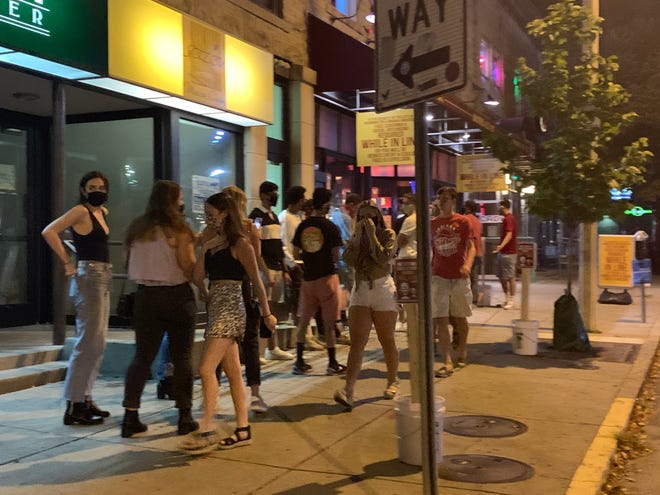 Students gather outside Brothers Bar and Grill near the Indiana University campus in Bloomington, Ind., on Sept. 3, 2020.