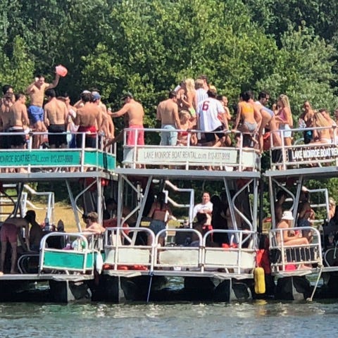 Indiana University students gather on boats on Lak