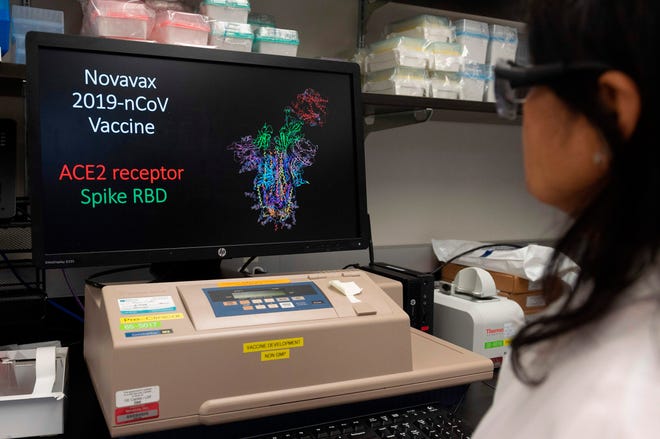 Dr. Nita Patel, director of antibody discovery and Vaccine development, looks at a computer model showing the protein structure of a potential COVID-19 vaccine at Novavax labs in Rockville, Maryland on March 20, one of the labs developing a vaccine. Volunteers are being sought for Phase 3 clinical trials for the vaccine at Womack Army Medical Center at Fort Bragg.