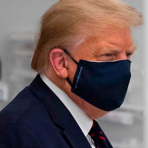 President Donald Trump tours a lab making componen