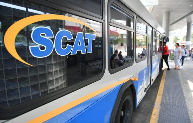 Passengers board a SCAT bus at the Lemon Ave. transfer station.
