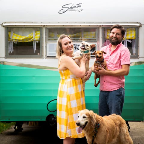 Jenna Beall Mueller and Adam Mueller stand in fron