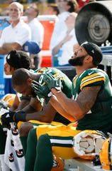 Green Bay Packers players, from left, Kevin King, Martellus Bennett and Lance Kendricks sit in protest during the national anthem before their game against the Cincinnati Bengals at Lambeau Field in Green Bay.
 Associated Press
Green Bay Packers players (from left) Kevin King, Martellus Bennett and Lance Kendricks sit in protest during the national anthem before their game against the Cincinnati Bengals at Lambeau Field on Sunday in Green Bay.