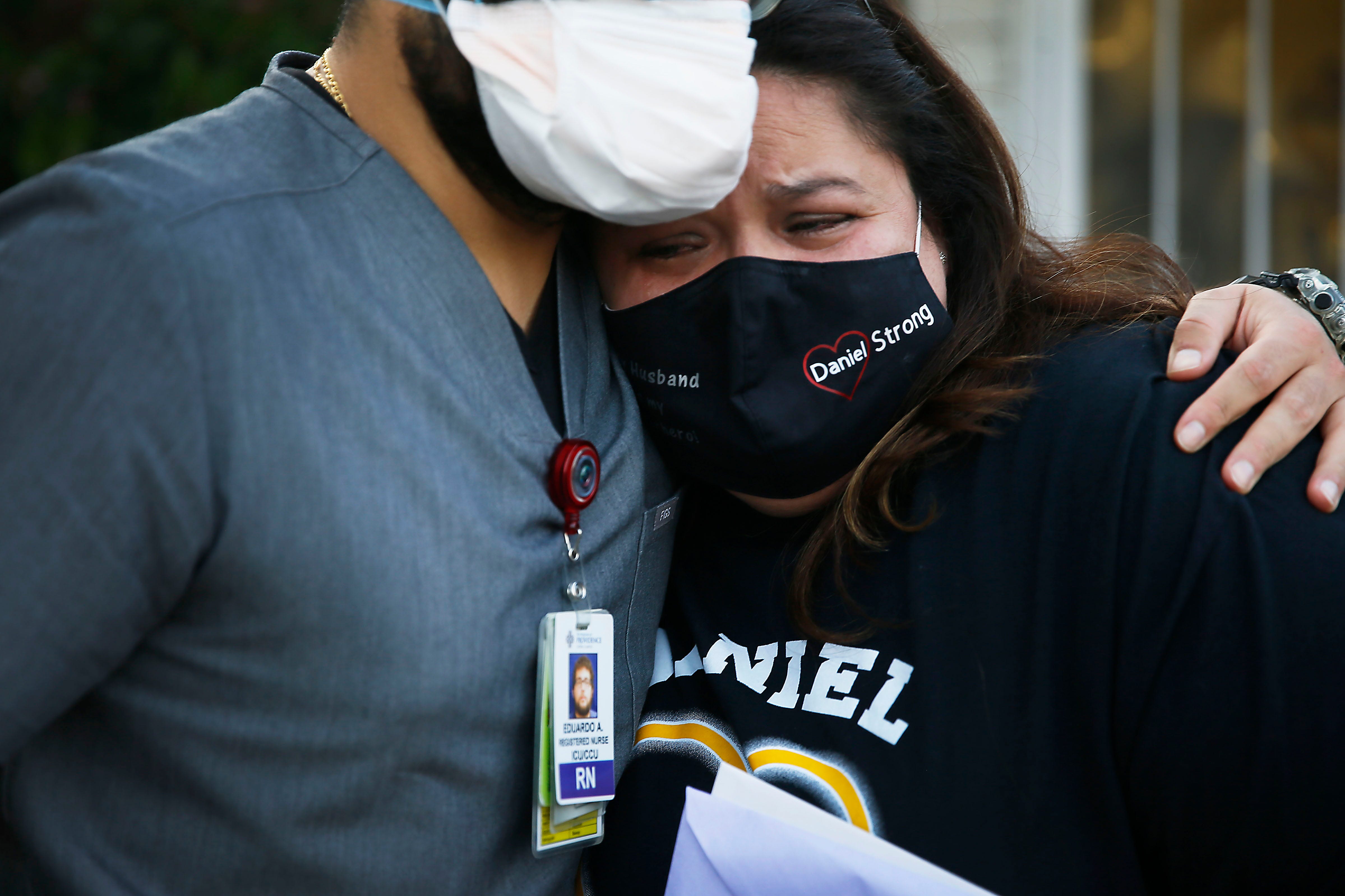 Eduardo Aguirre, a Sierra Medical Center Intensive Care Unit nurse, stops by to see Erika Castor-Morales to pay his respects to her late husband, Daniel Morales. Daniel Morales, a dialysis nurse at DaVita Dialysis, caught the coronavirus and died Aug. 4. Aguirre was one of the nurses that treated Morales.