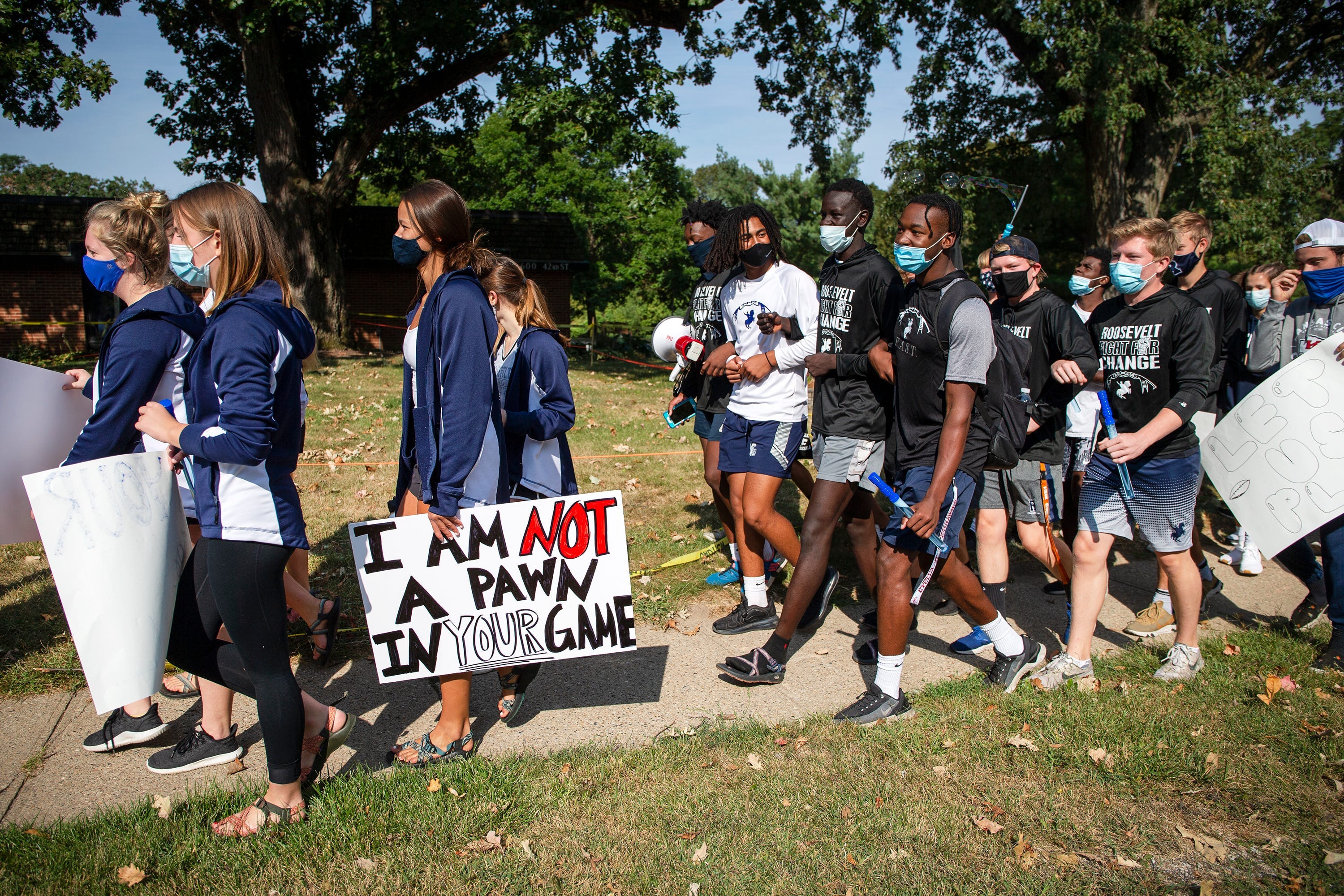 Public school students in Des Moines, Iowa, and supporters march to the governor's mansion Sept. 7 to protest the cancellation of fall and winter extracurricular programs.