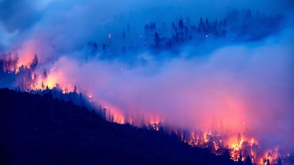 The Creek Fire burns along a hillside in the Casca