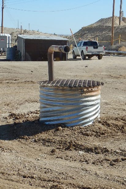 Short cisterns, like this one pictured on a Berry Petroleum lease in the Midway-Sunset field, are used to contain oil spills.