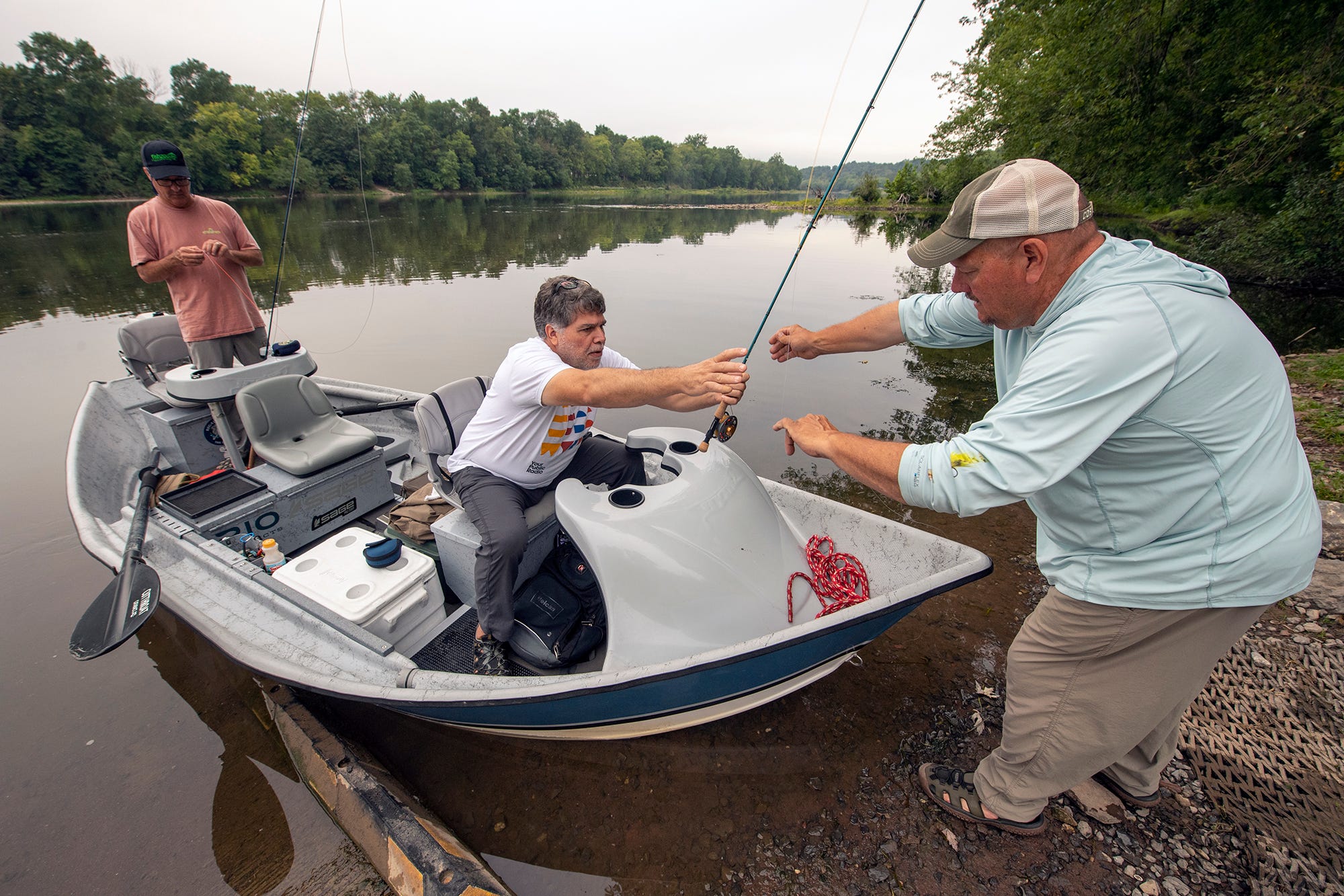 From right, Brian Shumaker helps Scott Wehage, 52, from Jarrettsville, Md. and Mike Stotler, 50, from Forrest Hill, Md. board his boat for a fishing trip on the Juniata River near Newport, Pa. The Juniata is a major tributary of the Susquehanna River.