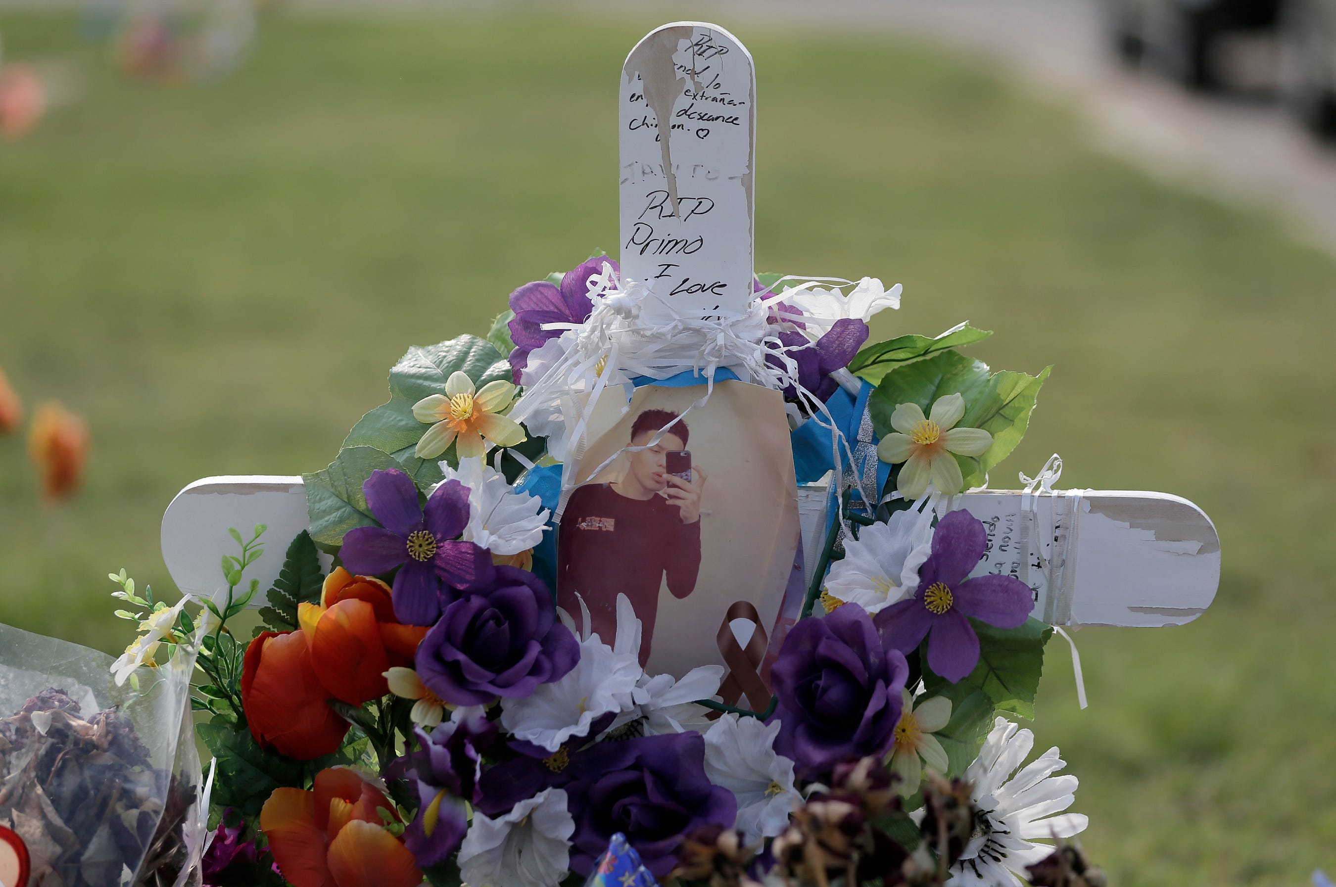 Patricia Torres visits her son Gustavo Cervantes' gravesite Wednesday evening at Mount Carmel Cemetery in East El Paso. He was the driver in a wreck that killed seven and injured three.