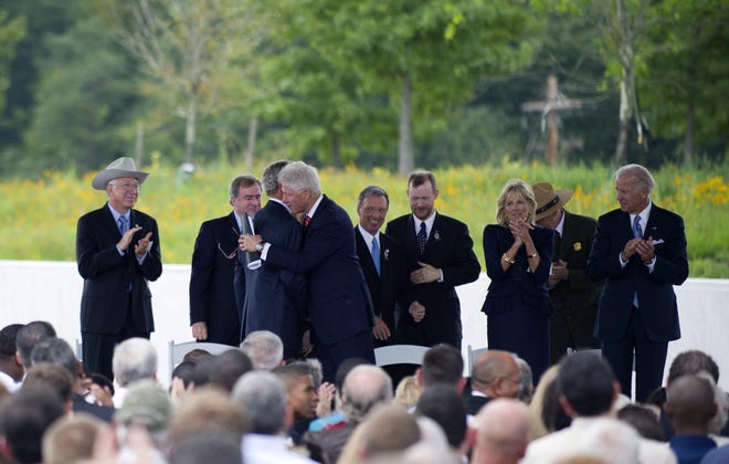 Former Presidents Bill Clinton and George W. Bush embrace following their speeches at the Flight 93 Memorial, September 10, 2011 in Shanksville, Pennsylvania.  The Flight 93 National Memorial was formally dedicated with Bush, Clinton, Vice President Joe Biden, Secretary of the Interior Ken Salazar, House Speaker John Boehner and members of Congress in attendance.  An estimated crowd of 5,000 watched as the memorial wall was unveiled with the names of the 40 passengers on the plane that crashed on September 11, 2001.