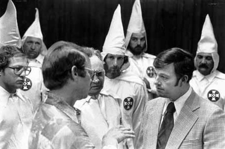 John Paul Rogers, right, Grand Dragon of the Florida United Klans of America, speaks with Dundee Mayor Lonnie Adams. Rogers and a dozen robed and hooded Klansmen showed up at a 1979 Dundee City Commission meeting in support of Dundee police officer Sam Clark, who had fired his gun while pursuing a suspect. A local civil rights group was calling for Clark's resignation. Clark was later arrested as one of the witnesses to the severe beating of two men at a Klan gathering in Orlando.