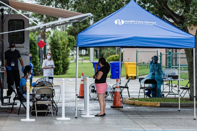 At the coronavirus testing site in the parking lot of the Greenacres Community Center on Aug. 26, people wait to check in and get tested for COVID-19.