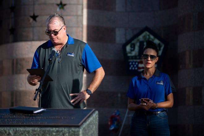 Michael Randall, left, and Rosemary Zore, right, read the names of those that died during a 9/11 memorial organized by The Fallen Officers at Freedom Park in Naples on Friday, September 11, 2020.