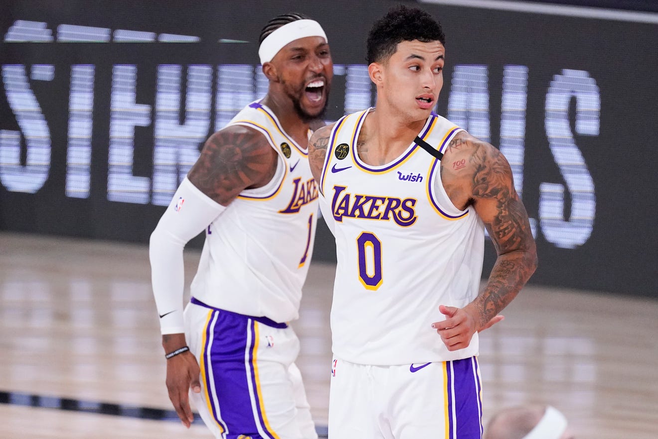Los Angeles Lakers' Kentavious Caldwell-Pope, left, and Kyle Kuzma (Flint) celebrate in the closing minutes of a win over the Houston Rockets during the second half.