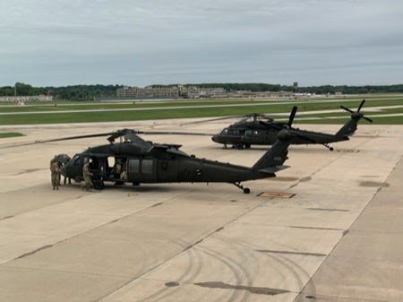 Black Hawk helicopter crews from the Wisconsin Army National Guard’s 1st Battalion, 147th Aviation prepare to depart Madison for California to battle wildfires Friday.