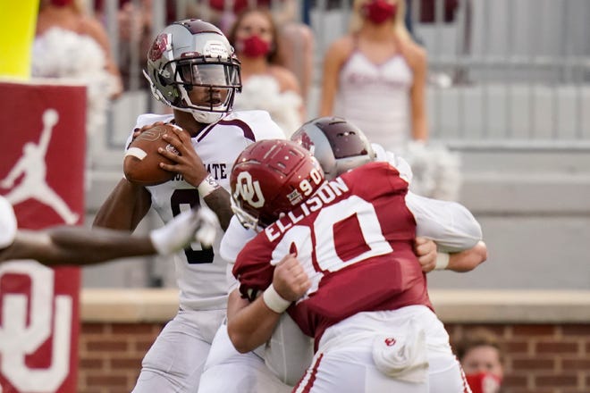 Missouri State quarterback Jaden Johnson, left, looks to pass in the first half of an NCAA college football game against Oklahoma Saturday, Sept. 12, 2020, in Norman, Okla. (AP Photo/Sue Ogrocki, Pool)