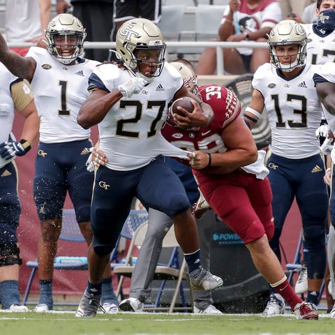 Georgia Tech running back Jordan Mason avoids a ta