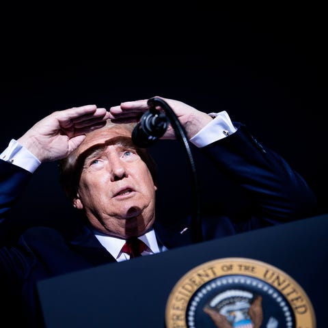 President Donald Trump looks at the crowd during a
