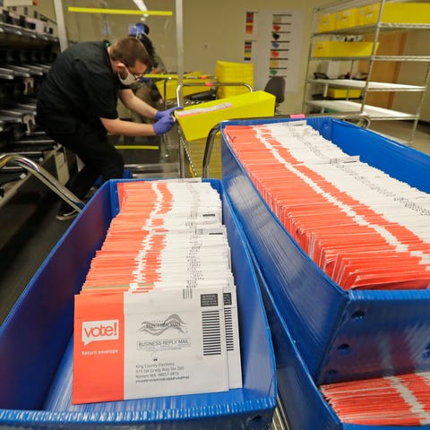 Vote-by-mail ballots are shown in sorting trays at
