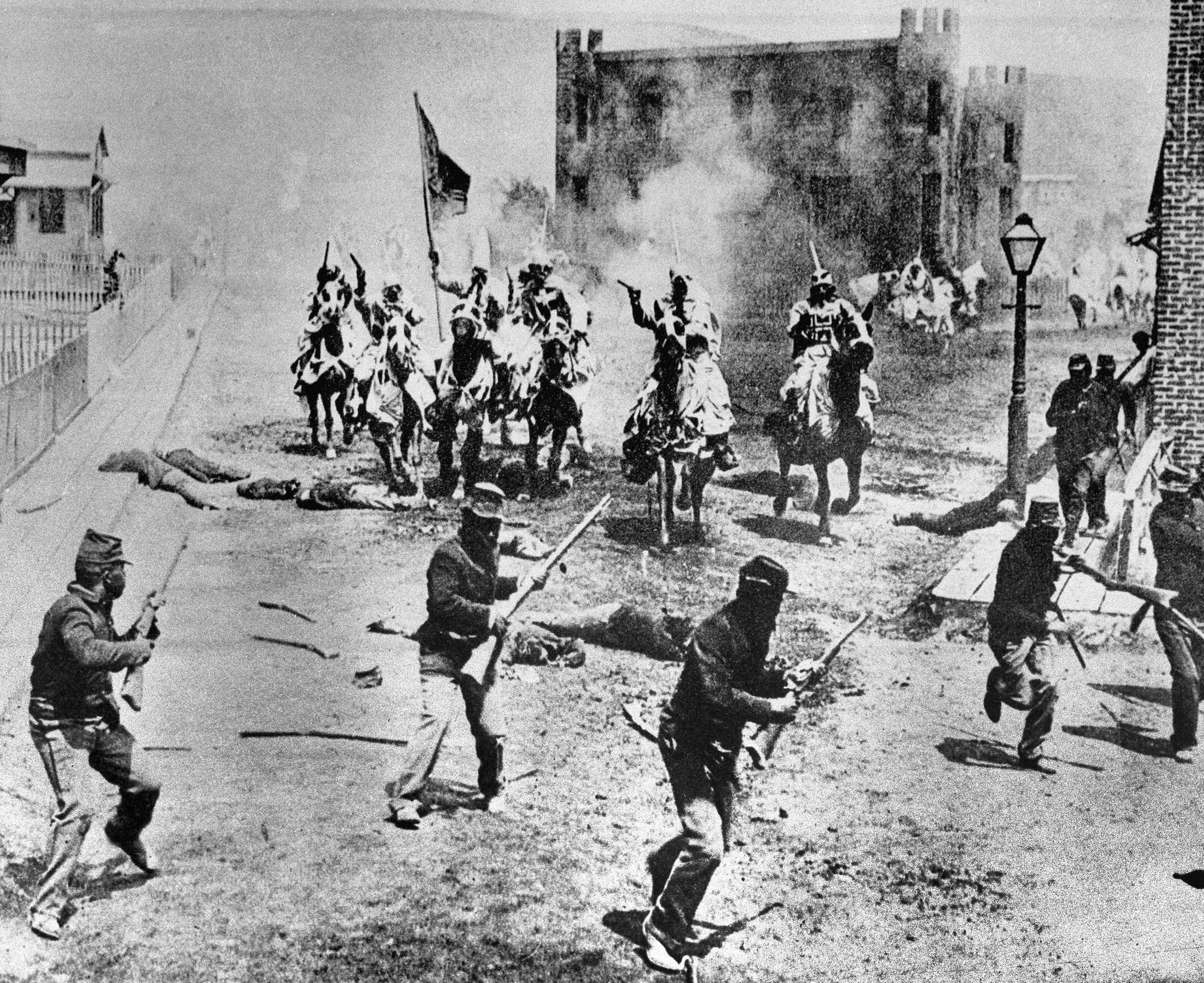 This 1914 file photo shows a scene from D.W. Griffith's "Birth of a Nation" movie depicting Ku Klux Klan members riding horses against soldiers, filmed in the Hollywood section of Los Angeles. The groundbreaking 1915 film, widely regarded as one of the most corrosively racist ever made, is viewed ever more harshly as the years pass.