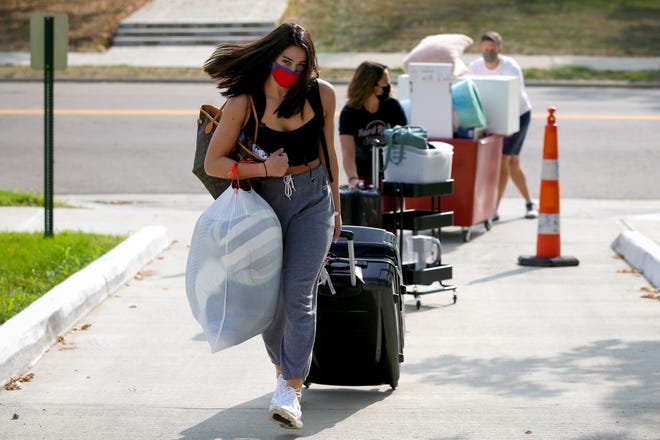 Kirsten Tibbitts, a second-year student, leads her mom, Heather, and dad, Jeff, up the ramp to Minnich Hall as she moves in, Monday, Sept. 14, 2020, at Miami University in Oxford, Ohio. 