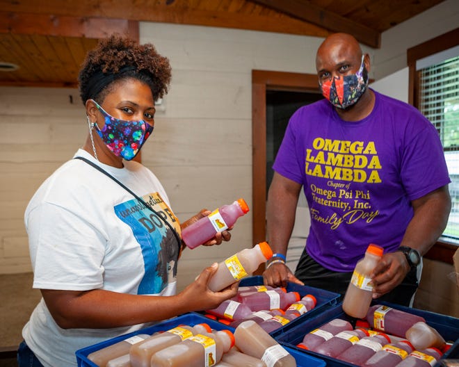 Downtown on the Farm 2020, benefiting Locally Owned Murfreesboro scholarship fund: Franklin Tea owners Mylikia and Germayle Franklin dole out their drinks.