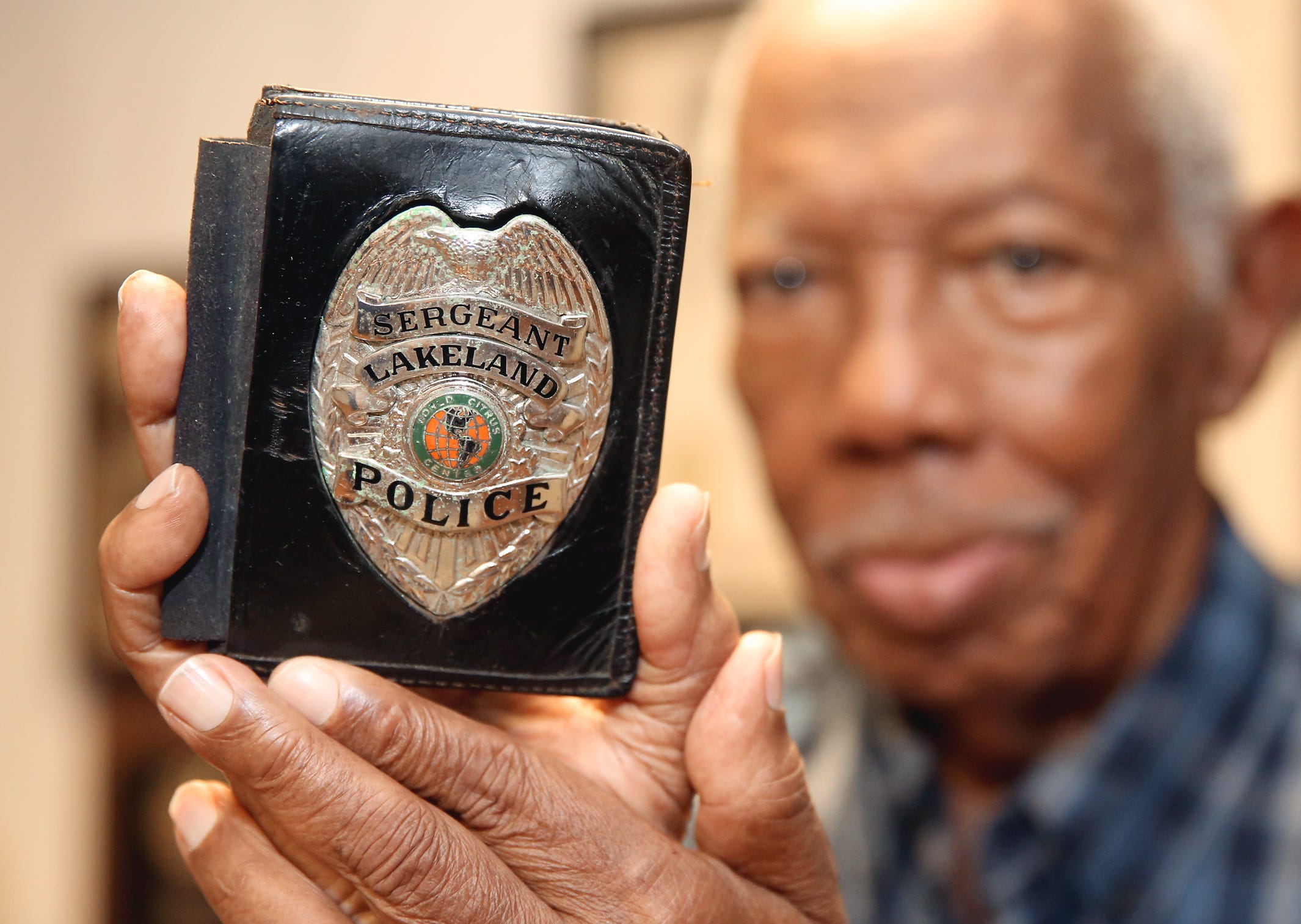 Edgar Pickett, retired Lakeland Police Department sergeant, is pictured with his badge at his home in Lakeland in this file photo. Pickett was the first Black detective and first forensic specialist for LPD.