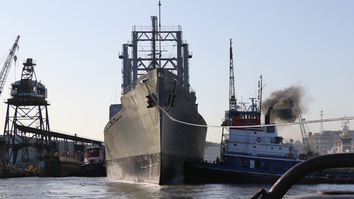 Tugboats pull the Cape Avinof, a cargo ship, from the Brooklyn Navy Yard into the East River.