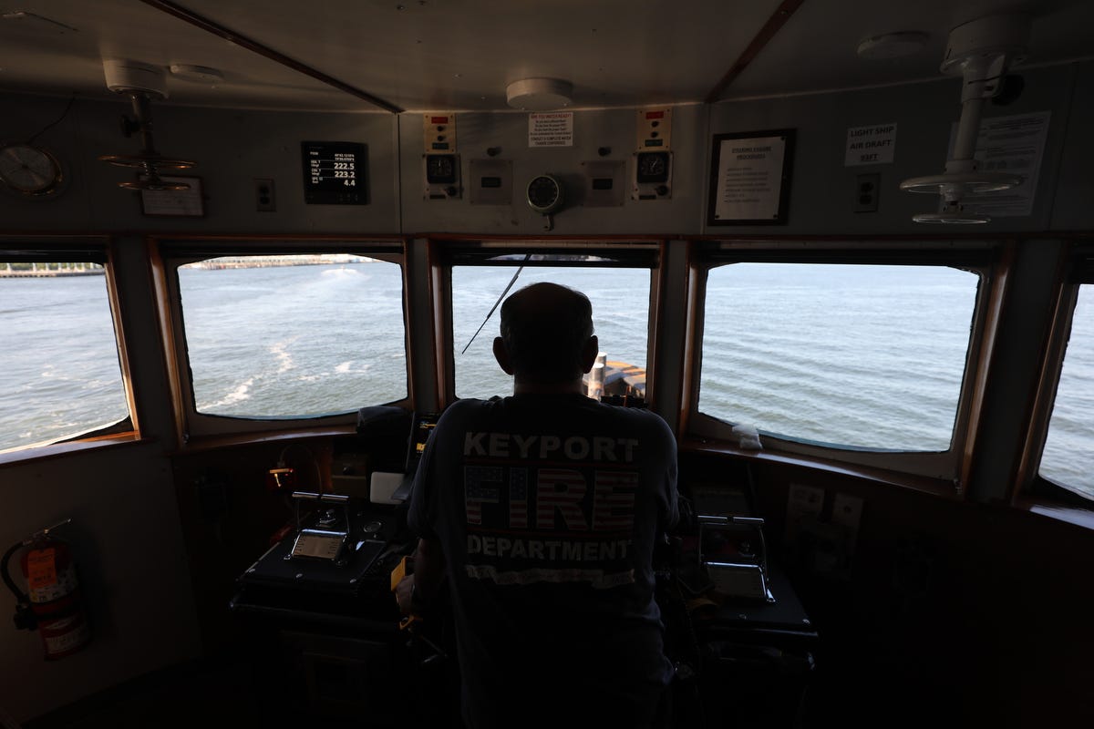 Mike Vinik, owner and operator of Vinik Marine, at the wheel of one of his tugboats.